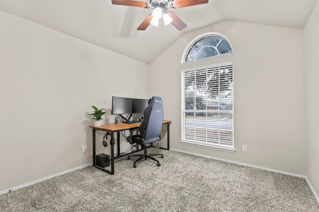 Office space featuring lofted ceiling, carpet floors, ceiling fan, and baseboards | Image 29