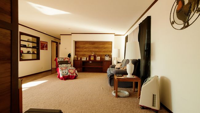 Living area featuring carpet and ornamental molding | Image 24