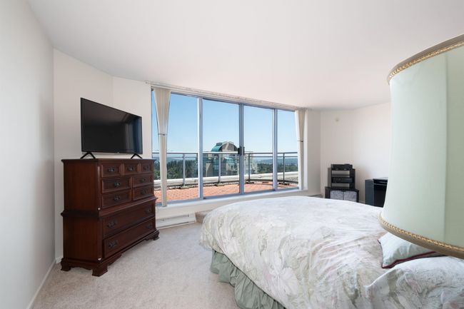 Bedroom with baseboard heating, baseboards, and carpet | Image 19