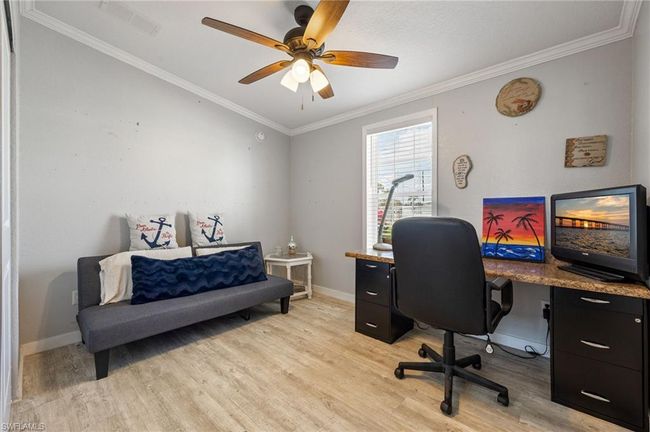 Office space featuring ceiling fan, crown molding, visible vents, light wood-style flooring, and baseboards | Image 20