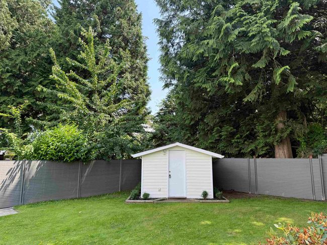 Fenced backyard with a storage shed | Image 33