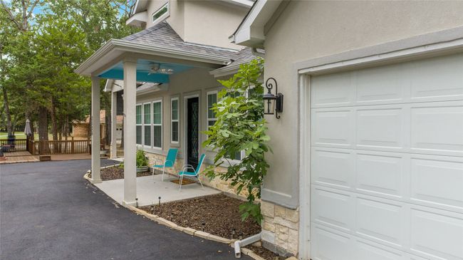 Property entrance featuring a garage, stucco siding, and stone siding | Image 39