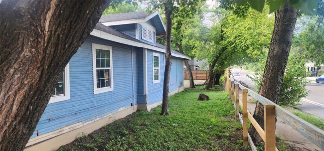 View of home's exterior with a shingled roof | Image 6
