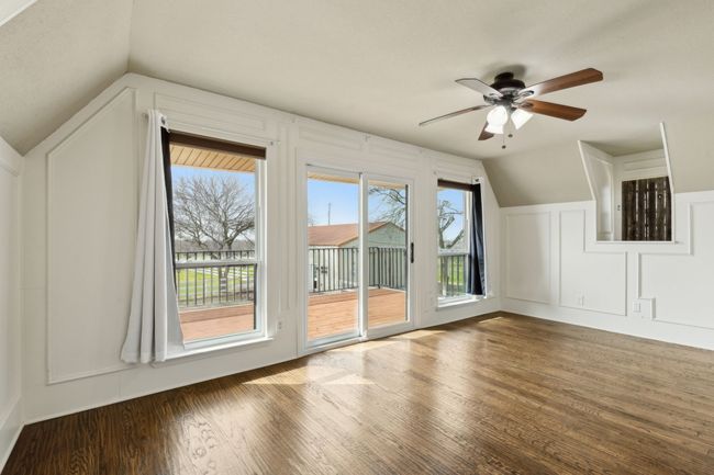 Additional living space with lofted ceiling, wood finished floors, a ceiling fan, and a decorative wall | Image 22
