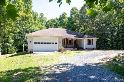 Ranch-style home featuring a garage, a front yard, and a porch | Image 3