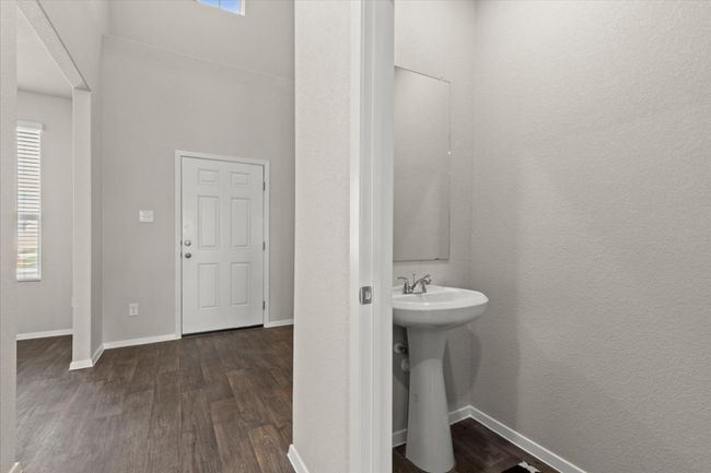 Bathroom featuring wood finished floors, baseboards, and a sink | Image 29