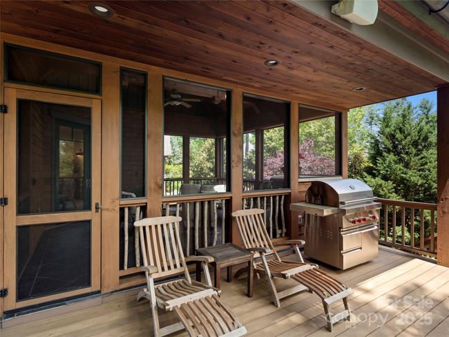 Partially covered deck provides a protected area for grilling and relaxing. | Image 21