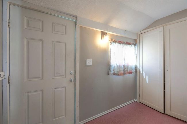 Doorway to outside with baseboards, lofted ceiling, and carpet flooring | Image 41