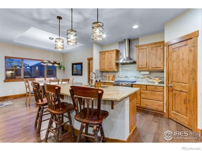 Upon entering the home, be greeted by high ceilings, wood floors, and an open-concept kitchen/living room space. | Image 3