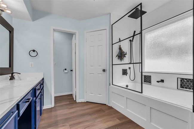 Updated tub and shower with custom tile, rain showerhead and custom niches. | Image 28