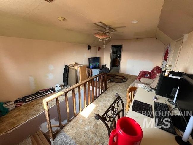 Interior space featuring an upstairs landing, a ceiling fan, and carpet floors | Image 9