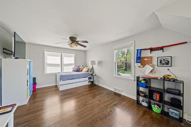 Bedroom featuring baseboards, visible vents, wood finished floors, and ceiling fan | Image 21