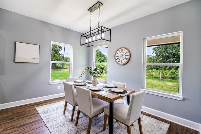 Dining room featuring baseboards and dark wood-style floors | Image 12