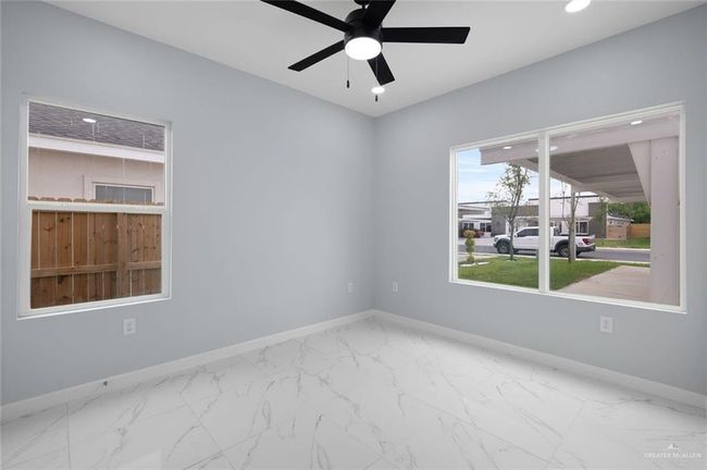 Spare room featuring baseboards, recessed lighting, ceiling fan, and marble look tiles | Image 9