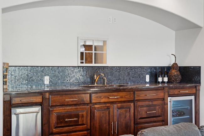 Bar featuring a sink, wine cooler, and tasteful backsplash | Image 34