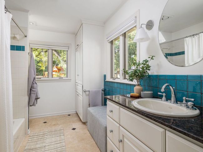 Bathroom with vanity, tile patterned floors, and a shower / bath combo. | Image 17