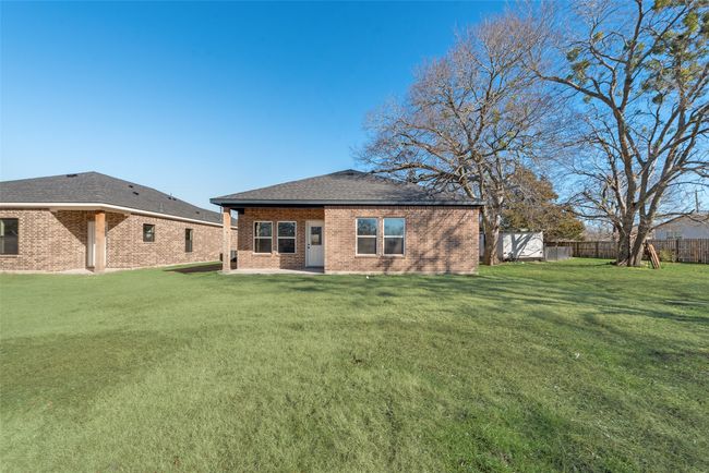 Rear view of property with brick siding and a shingled roof | Image 27