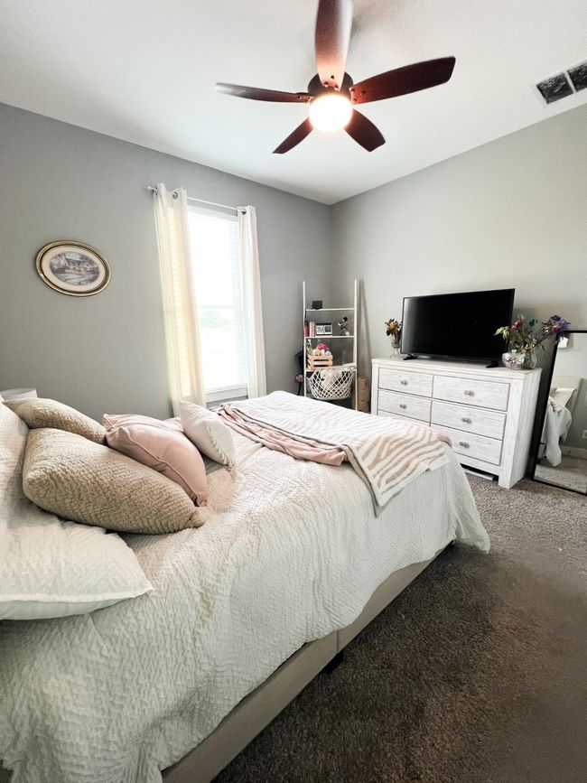 Bedroom with carpet flooring and ceiling fan | Image 9