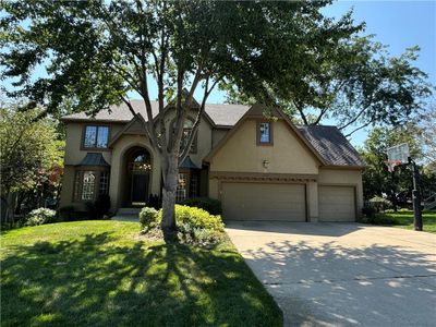 View of front of house with a garage and a front yard | Image 1