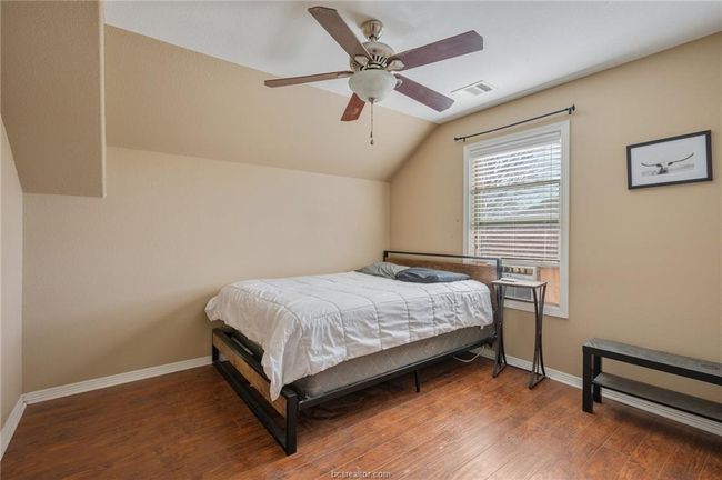 Bedroom featuring vaulted ceiling, wood finished floors, and a ceiling fan | Image 20