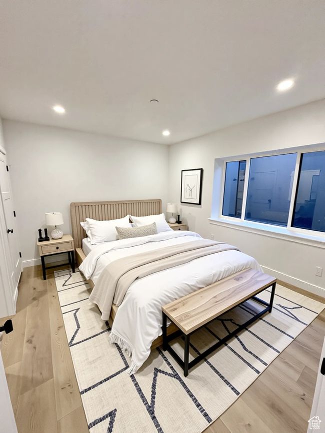 Bedroom featuring light wood finished floors and recessed lighting | Image 5
