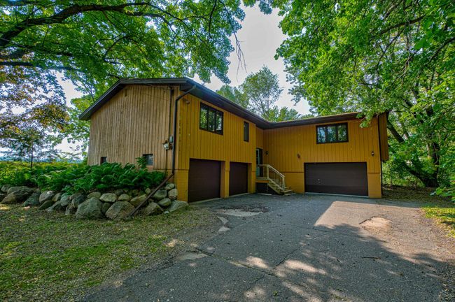Two attached garages with four stalls, plus a handy workshop area, offer endless possibilities for storage, projects, or even your next big adventure! | Image 26