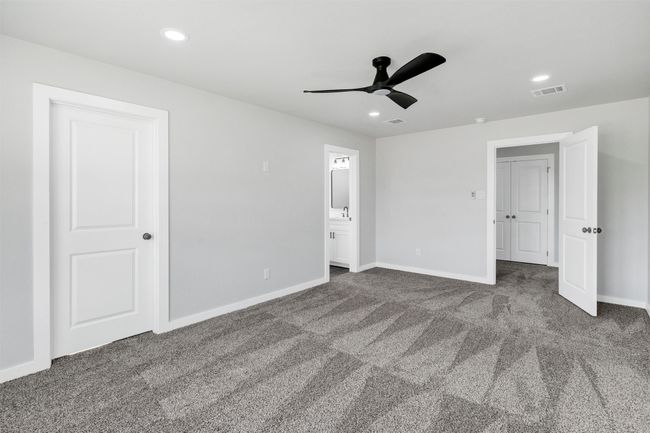 Unfurnished bedroom with carpet flooring, baseboards, recessed lighting, ensuite bathroom, and a ceiling fan | Image 24