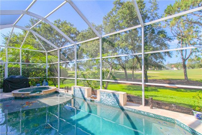 View of pool featuring a yard, a lanai, an in ground hot tub, and area for grilling | Image 14