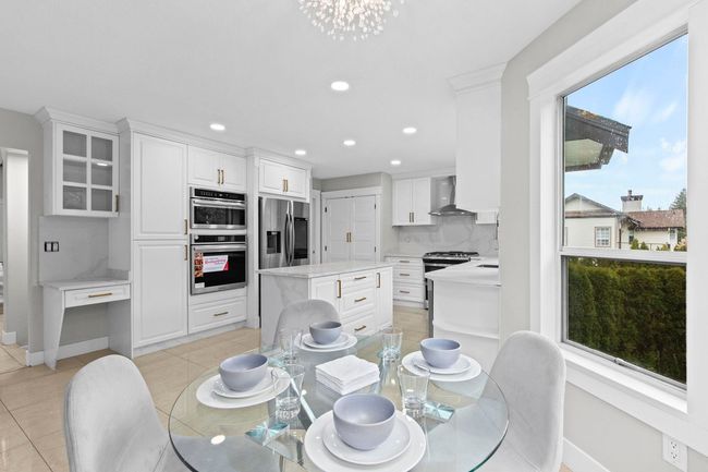 Dining room featuring recessed lighting, an inviting chandelier, and a wealth of natural light | Image 13