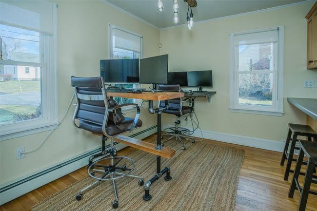 Home office with light hardwood / wood-style floors, a baseboard heating unit, and ornamental molding | Image 13