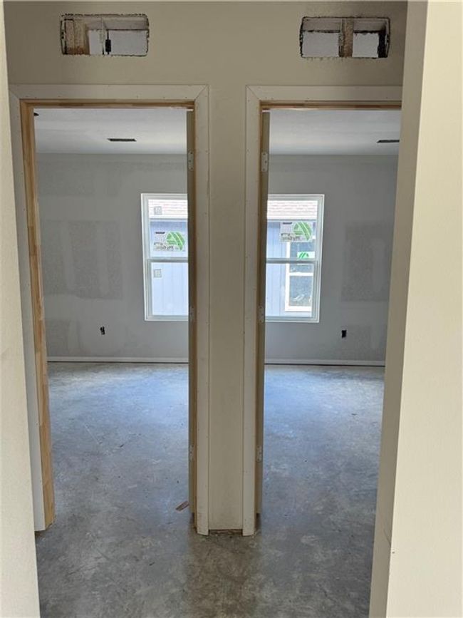 Corridor featuring unfinished concrete floors | Image 7