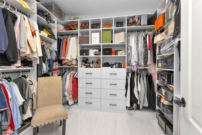 This walk-in closet is stunning with custom drawers and shelving. | Image 27