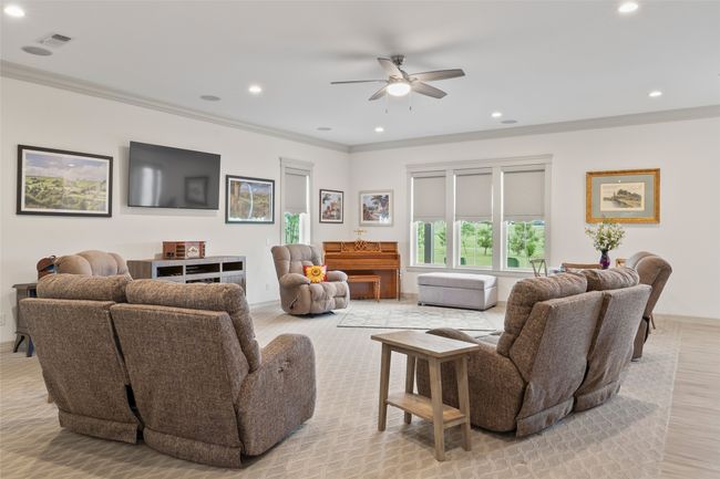 Living room featuring a ceiling fan, crown molding, and recessed lighting | Image 15