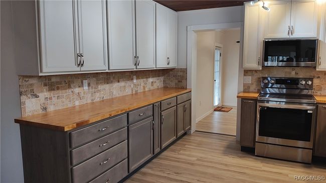 S side of kitchen door to master bedroom lies ahead | Image 8