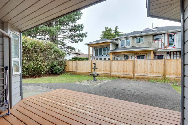Wooden deck with a fenced backyard and a patio area | Image 23