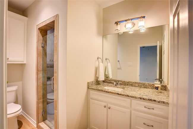 Full bathroom with vanity, a shower stall, and wood finished floors | Image 23