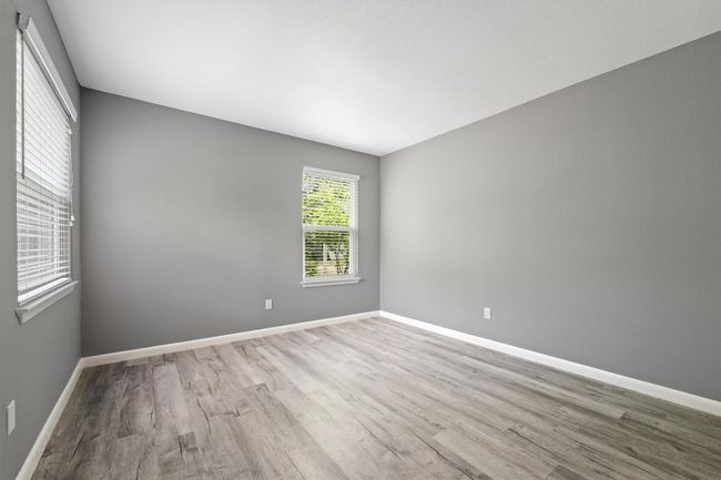 Spare room with wood finished floors and baseboards | Image 17