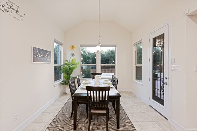 Dining room with plenty of natural light, lofted ceiling, and a chandelier | Image 17