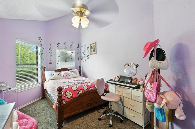 Bedroom with carpet flooring, lofted ceiling, and a ceiling fan | Image 17