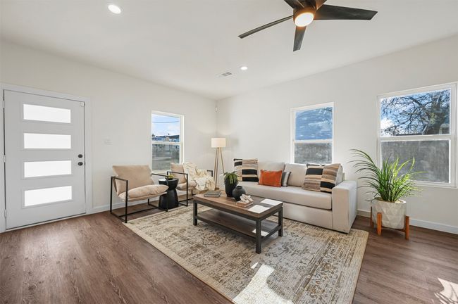Living area with wood finished floors, visible vents, plenty of natural light, and baseboards | Image 5