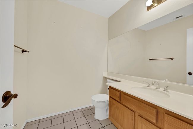 Bathroom featuring vanity, tile patterned flooring, toilet, and baseboards | Image 20