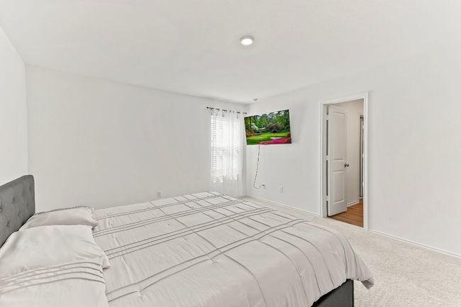 Carpeted bedroom with baseboards | Image 23