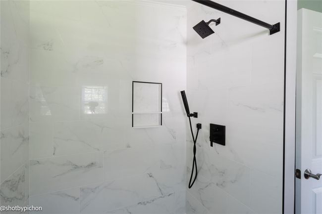 Bathroom view of a tile shower | Image 15
