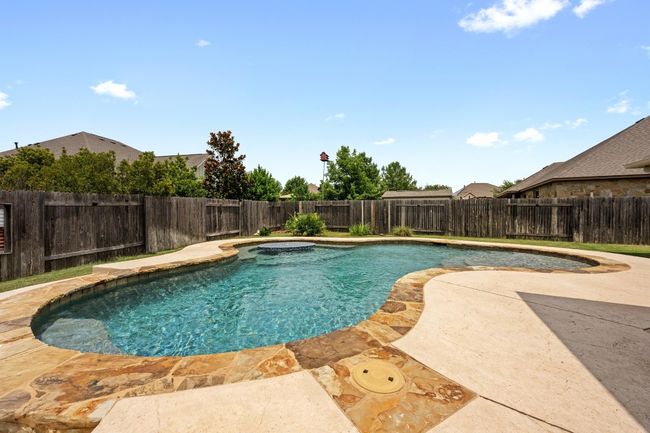 View of pool with a patio area and a fenced backyard | Image 32