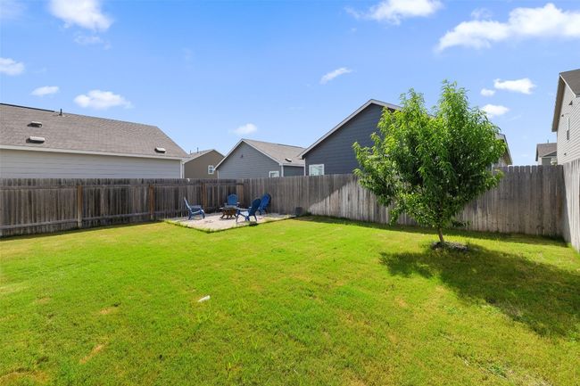 Fenced backyard featuring a fire pit and a patio area | Image 14
