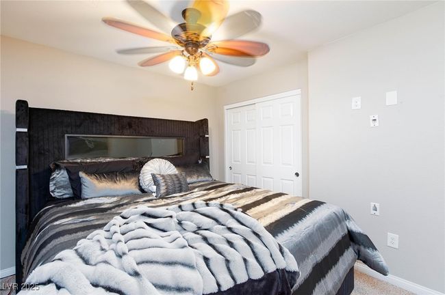 Bedroom with baseboards, a ceiling fan, carpet floors, and a closet | Image 31