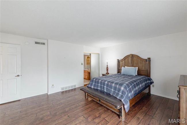 Bedroom with hardwood / wood-style floors and connected bathroom | Image 31