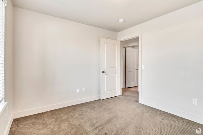 Empty room featuring light carpet and a smoke detector | Image 19