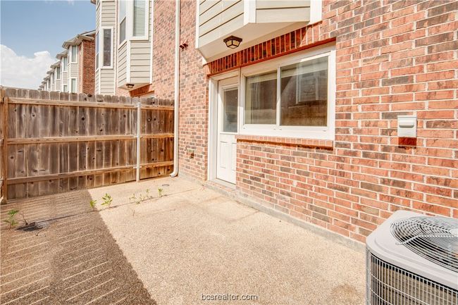 View of patio / terrace with central AC and fence | Image 13
