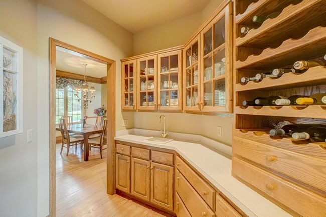 Entertaining is a breeze in the convenient Butler's Pantry and bar off the kitchen, complete with a serving sink and wine storage, leads to the formal dining room | Image 17